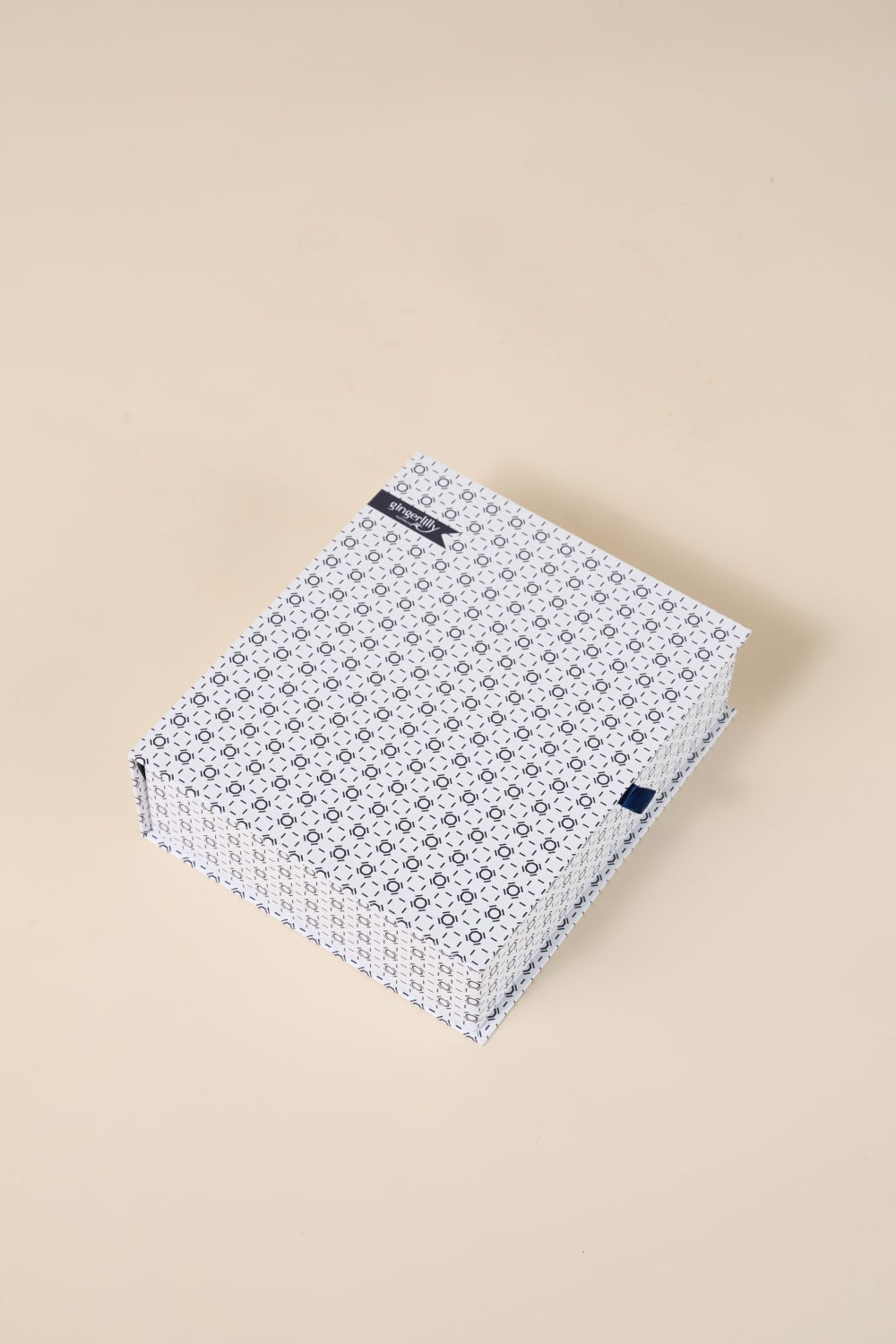Gingerlilly Sleepwear gift box with blue geometric pattern on beige background