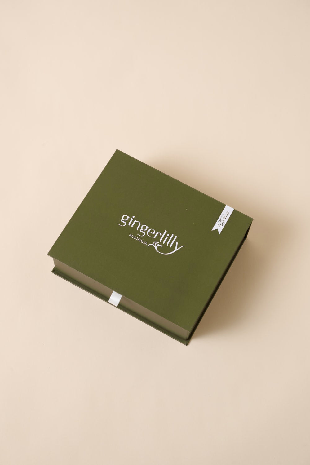 Gingerlilly Sleepwear green gift box with logo on beige background, Australian packaging
