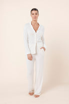 Woman wearing Athens Ribbed Long Pants Ivory, front view of soft ribbed lounge pants with relaxed wide leg fit