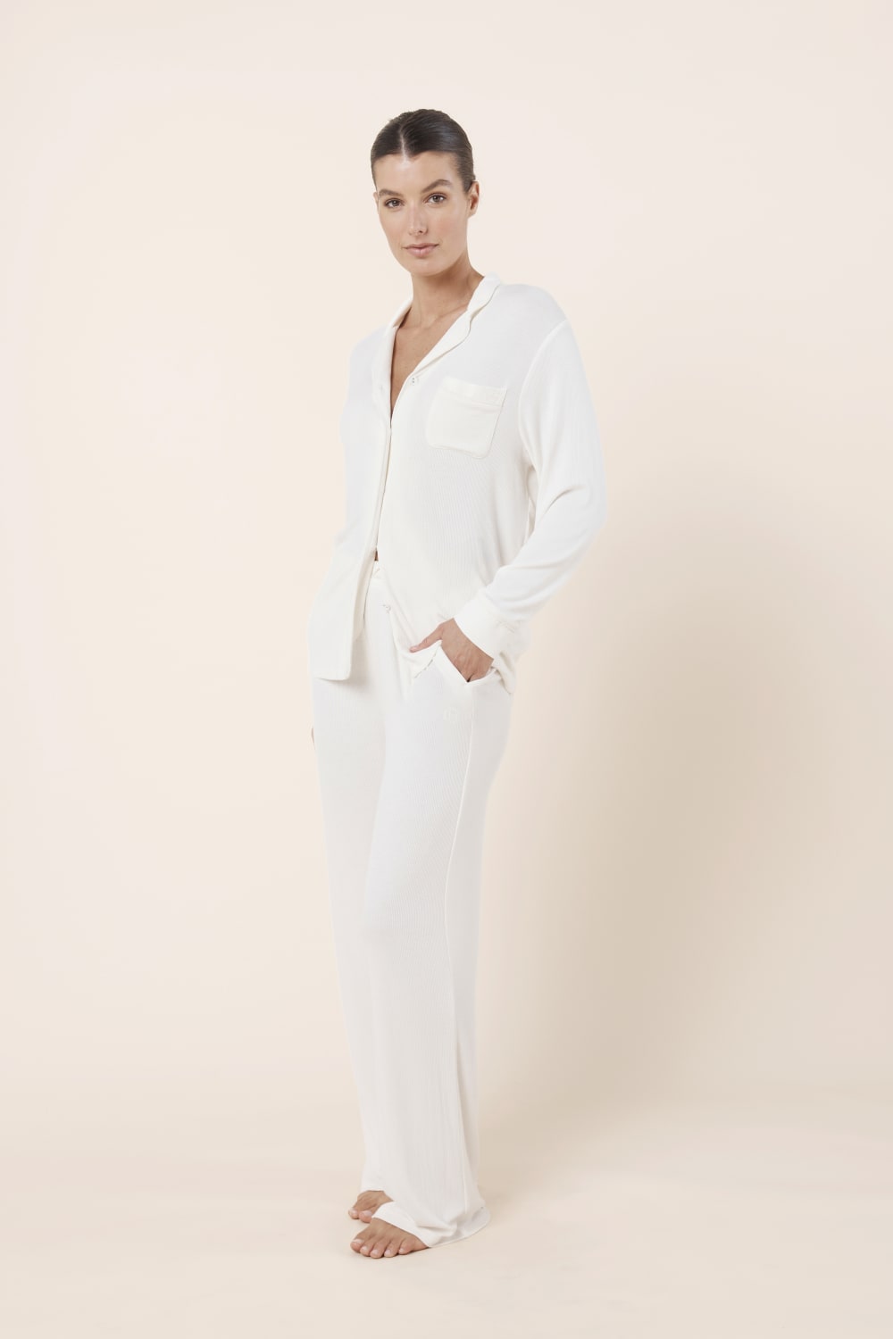 Woman wearing Athens Ribbed Long Pants Ivory styled with matching ribbed lounge top