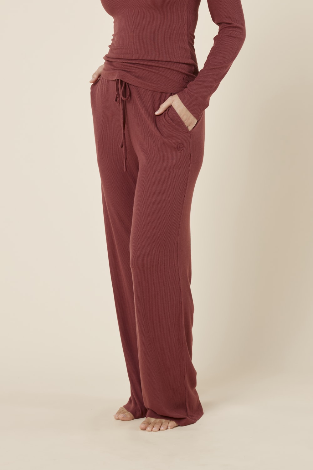 Woman wearing the Athens ribbed Long pant side on view with hand in pocket