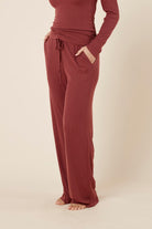 Woman wearing the Athens ribbed Long pant side on view with hand in pocket