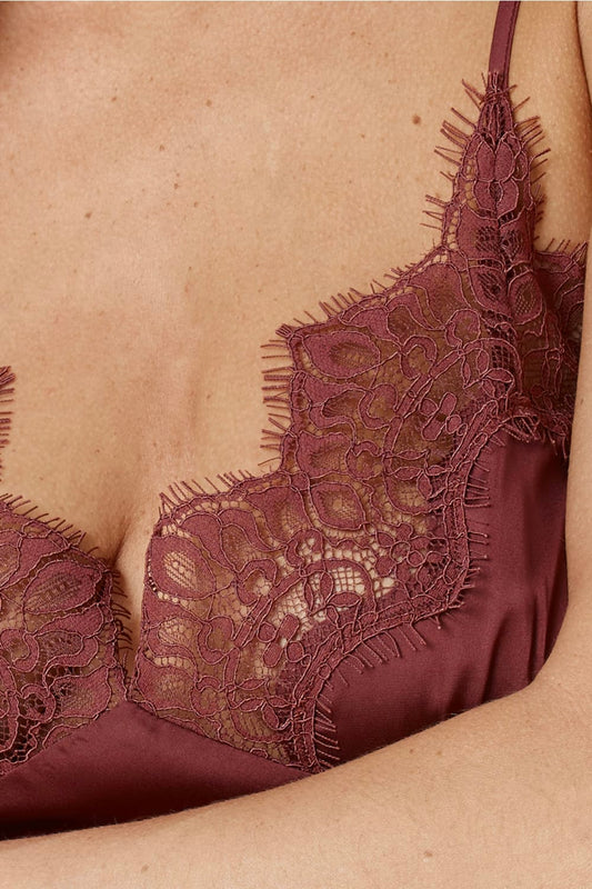 Close up of Azalia Silky Satin Short Chemise Burgundy showing the delicate lace trim at the neckline layered over smooth satin fabric.