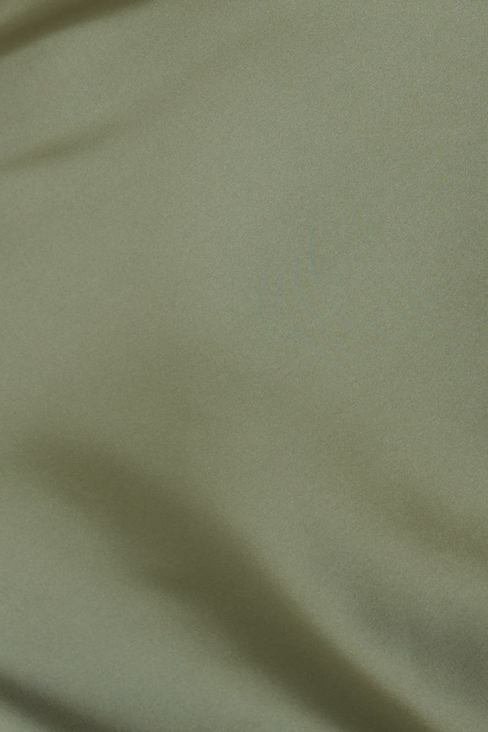 Close up of Azalia Silky Satin Short Chemise Olive fabric showing the smooth silky satin texture and soft olive green colour with gentle sheen.