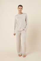 Woman wearing a brianna lounge set oatmeal on a plain beige background front on view