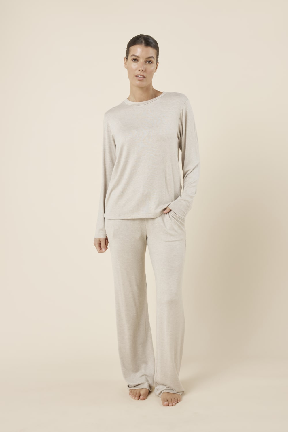 Woman wearing a brianna lounge set oatmeal on a plain beige background front on view