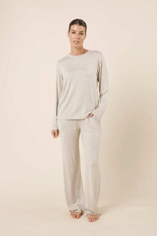 Woman wearing a brianna lounge set oatmeal on a plain beige background front on view