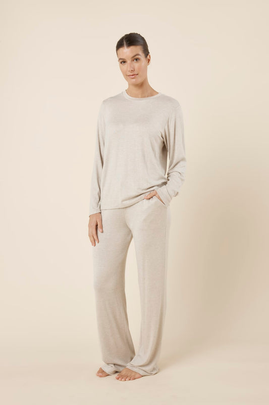 Woman wearing a brianna lounge set oatmeal on a plain beige background side on view