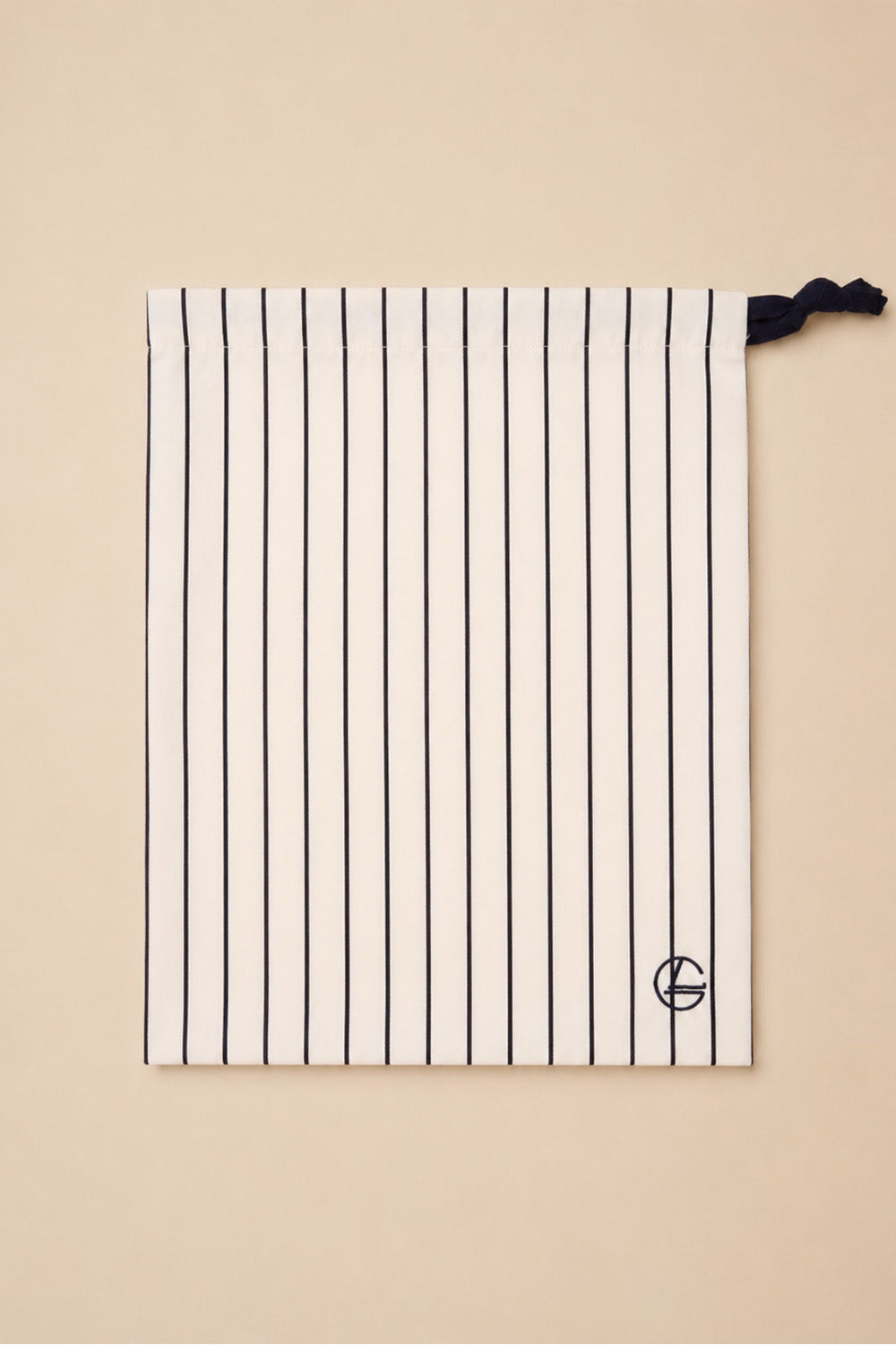 Willow Cotton Stripe PJ Set in Ivory, close-up of its matching ivory striped drawstring bag