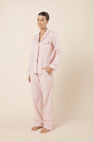 Woman wearing Octavia Cotton Stripe PJ Set Pink, side view of lightweight striped cotton sleepwear with straight leg pants