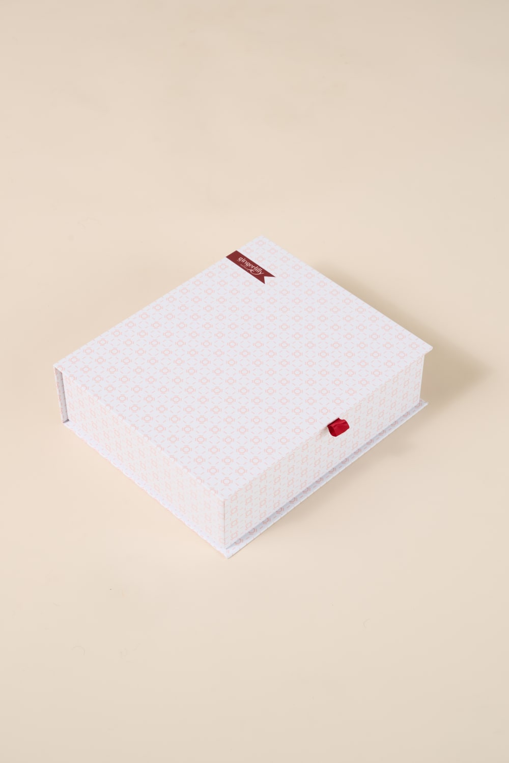 Pink patterned Gingerlilly Sleepwear gift box on a beige background