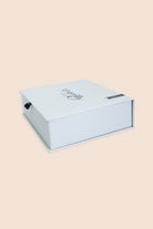 Pale blue Gingerlilly Sleepwear gift box on a beige background, featuring brand logo.