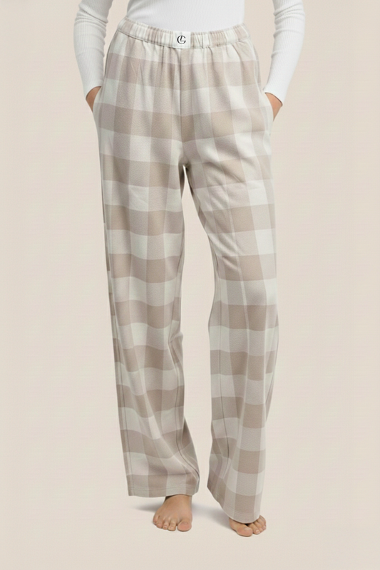 Plaid sarita buffalo check wide front pyjama pants worn by a woman on a beige background