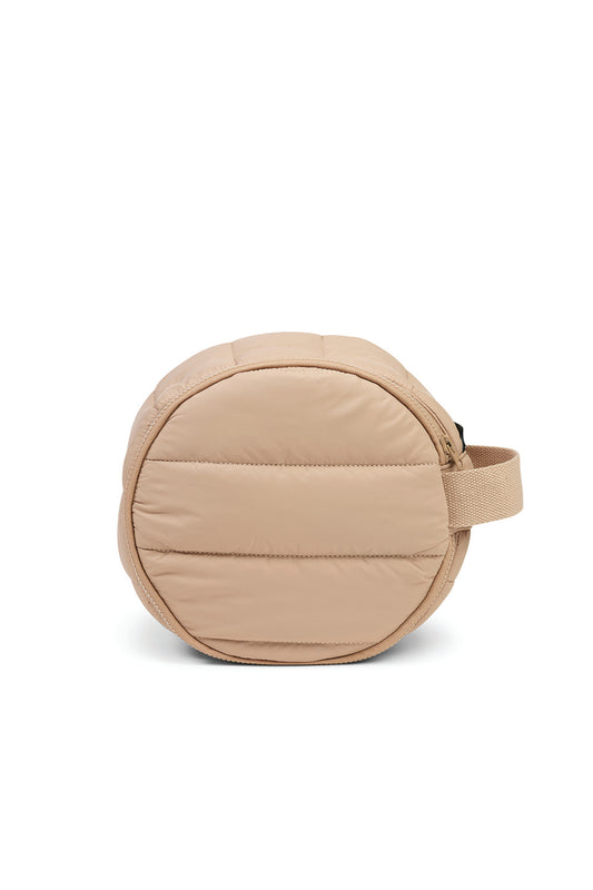 Round sand-colored quilted cosmetic bag with handle, displayed on white background