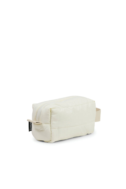 Ecru quilted toiletry bag with zipper and handle, styled for Gingerlilly Sleepwear.