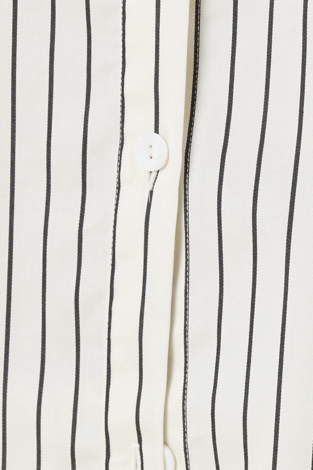 Close up of top of a ivory pin striped willow cotton stripe pyjama PJ set showing white buttons and seam
