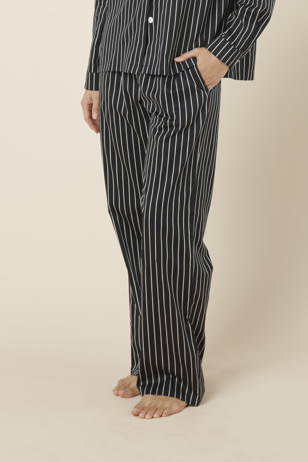 Person wearing Willow Cotton Striped Pant Black and white on a beige background