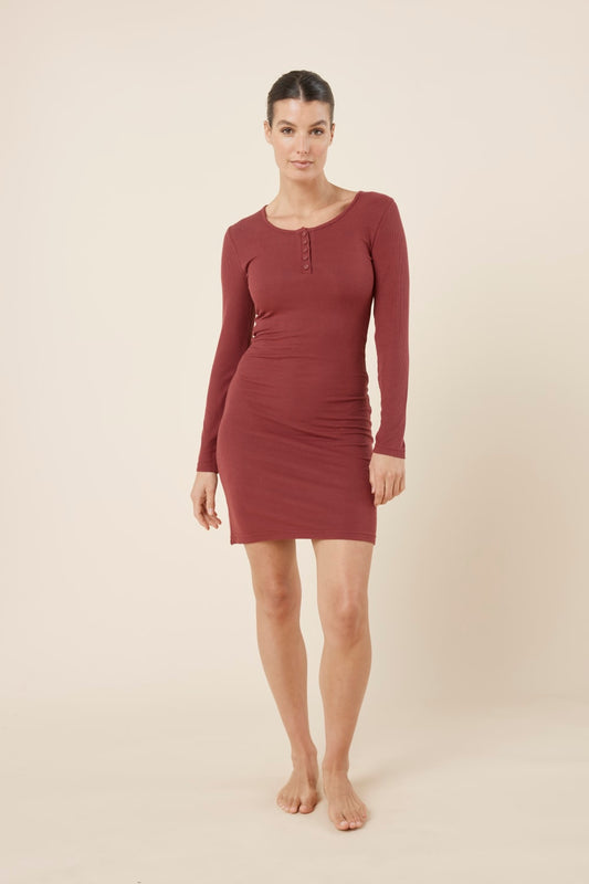 Woman wearing a burgundy bonnie ribbed long sleeve midi henley nightdress against a beige background front on view