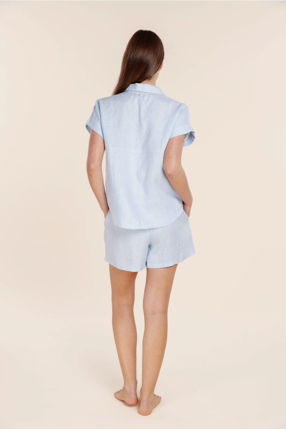 Woman wearing light blue Gingerlilly Sleepwear cotton pajamas, back view