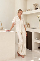 Woman wearing the Clarisse Short Sleeve Spot PJ Set in Ivory, lifestyle view
