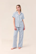Woman wearing the Lisa Stripe Long Pant PJ Set in Blue, front view of short sleeve shirt and long pants