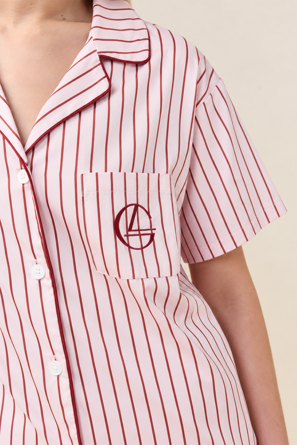Close-up of the Poppy Stripe Short PJ Set in Pink, showing the chest pocket with embroidered logo