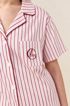 Close-up of the Poppy Stripe Short PJ Set in Pink, showing the chest pocket with embroidered logo