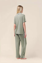 Woman wearing the Vanessa Bamboo Long Pant PJ Set in Olive, back view showing the white side stripe