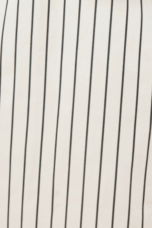 Close-up of a fabric with black vertical stripes of the lolita stripe night shirt in black and ecru ivory stripe.