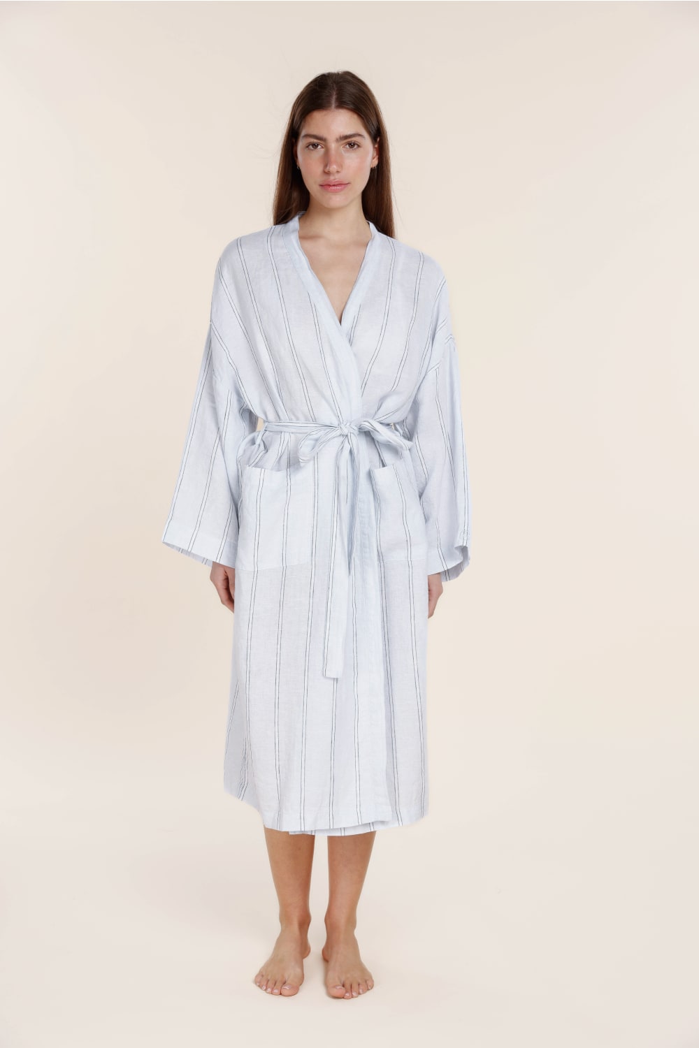 Woman wearing a Gingerlilly blue striped cotton robe, front view, relaxed sleepwear style