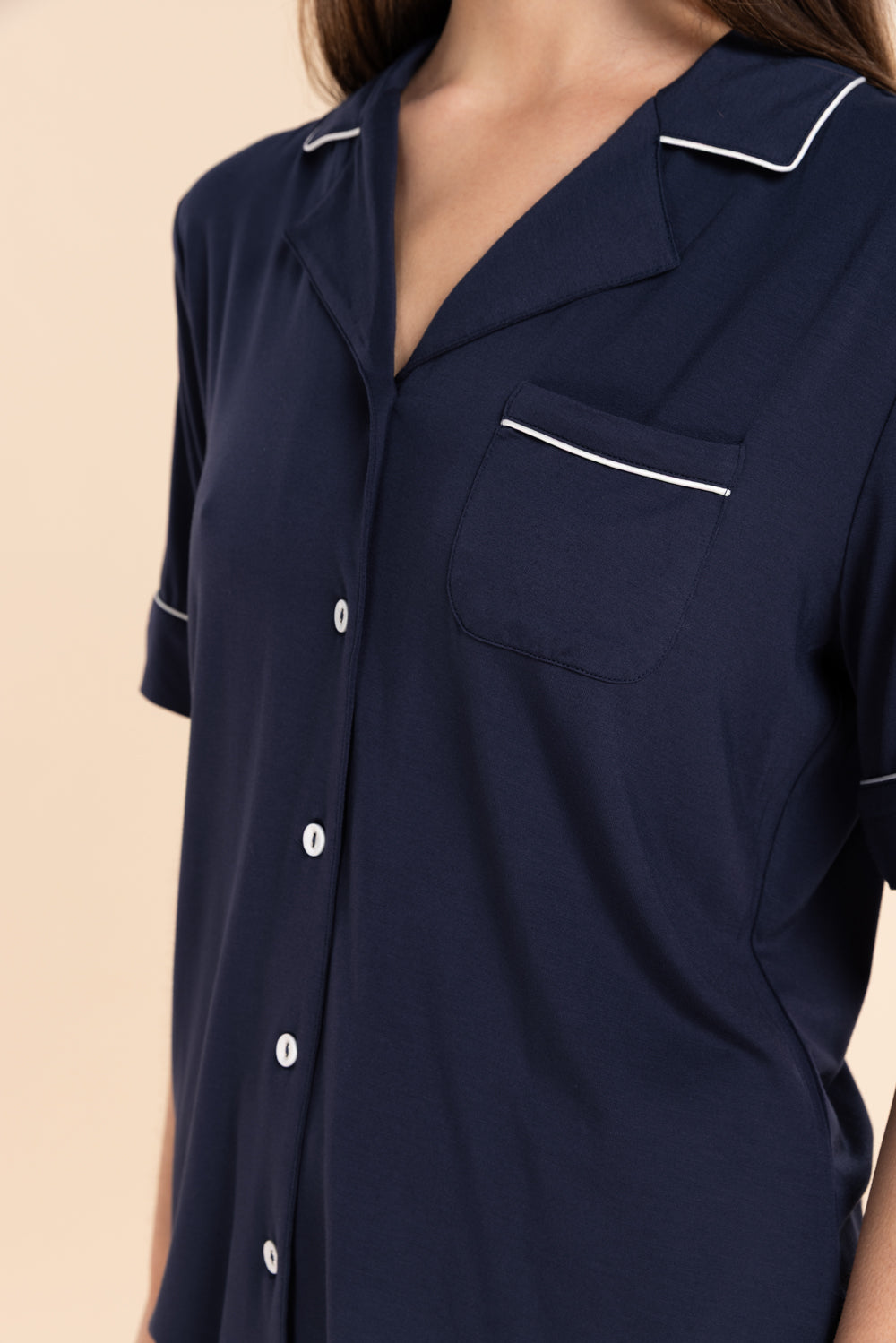 Close-up of the Sadie Bamboo Short PJ Set in Navy, showing the button-through front and pocket with white piping